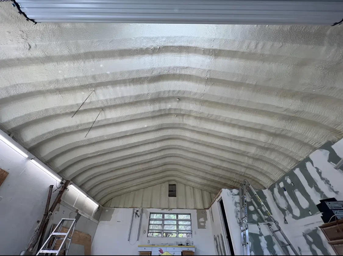 Spray polyurethane foam applied to the underside of a metal roof deck in Lamar